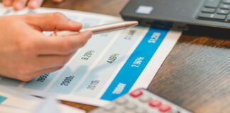 a close up shot of an agent pointing rates with a ballpen