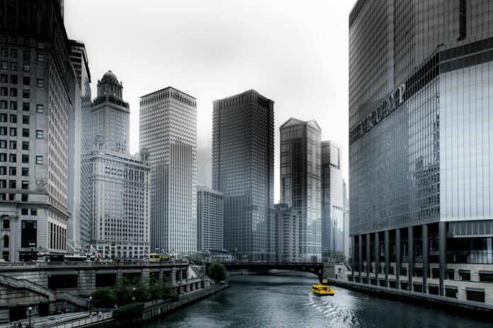 photo of boat going through river in between highrise buildings