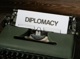 a white bond paper with diplomacy text on a typewriter