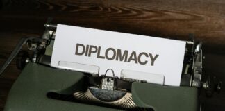 a white bond paper with diplomacy text on a typewriter