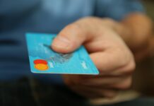 person holding debit card