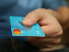 person holding debit card