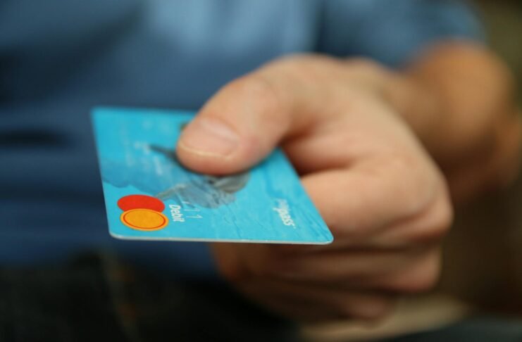 person holding debit card