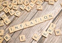 the word inflation is spelled out in scrabble letters