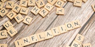 the word inflation is spelled out in scrabble letters