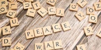 the word peace written on wooden letters