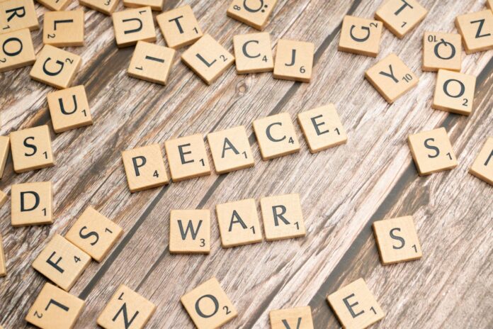 the word peace written on wooden letters