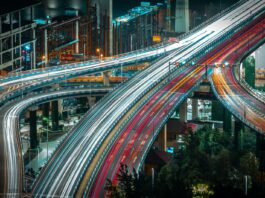 cars driving on urban highway in evening