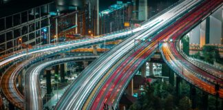 cars driving on urban highway in evening