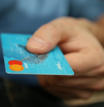 person holding debit card