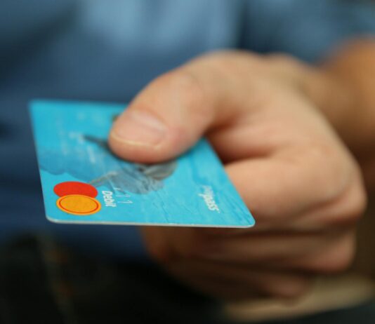 person holding debit card