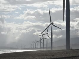 windmills on seashore under white clouds