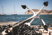 white and black anchor with chain at daytime