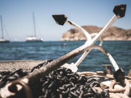 white and black anchor with chain at daytime